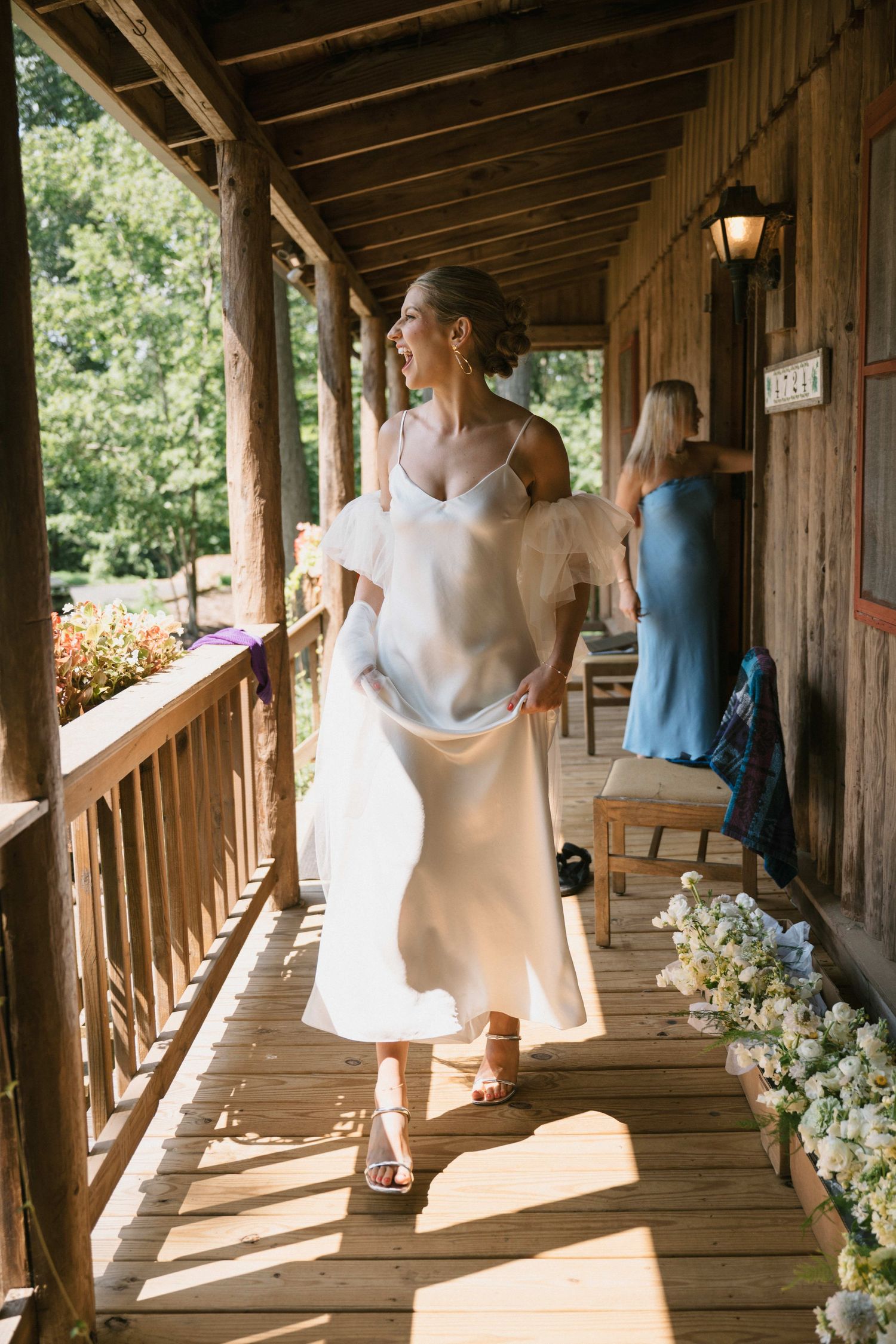 bride walks out of log cabin at camp hidden valley in maryland