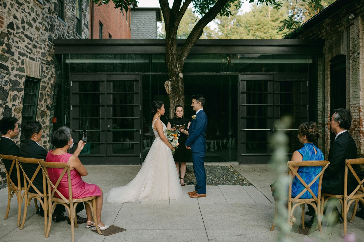 bride and groom hold hands during wedding ceremony at the mt washington mill dye house