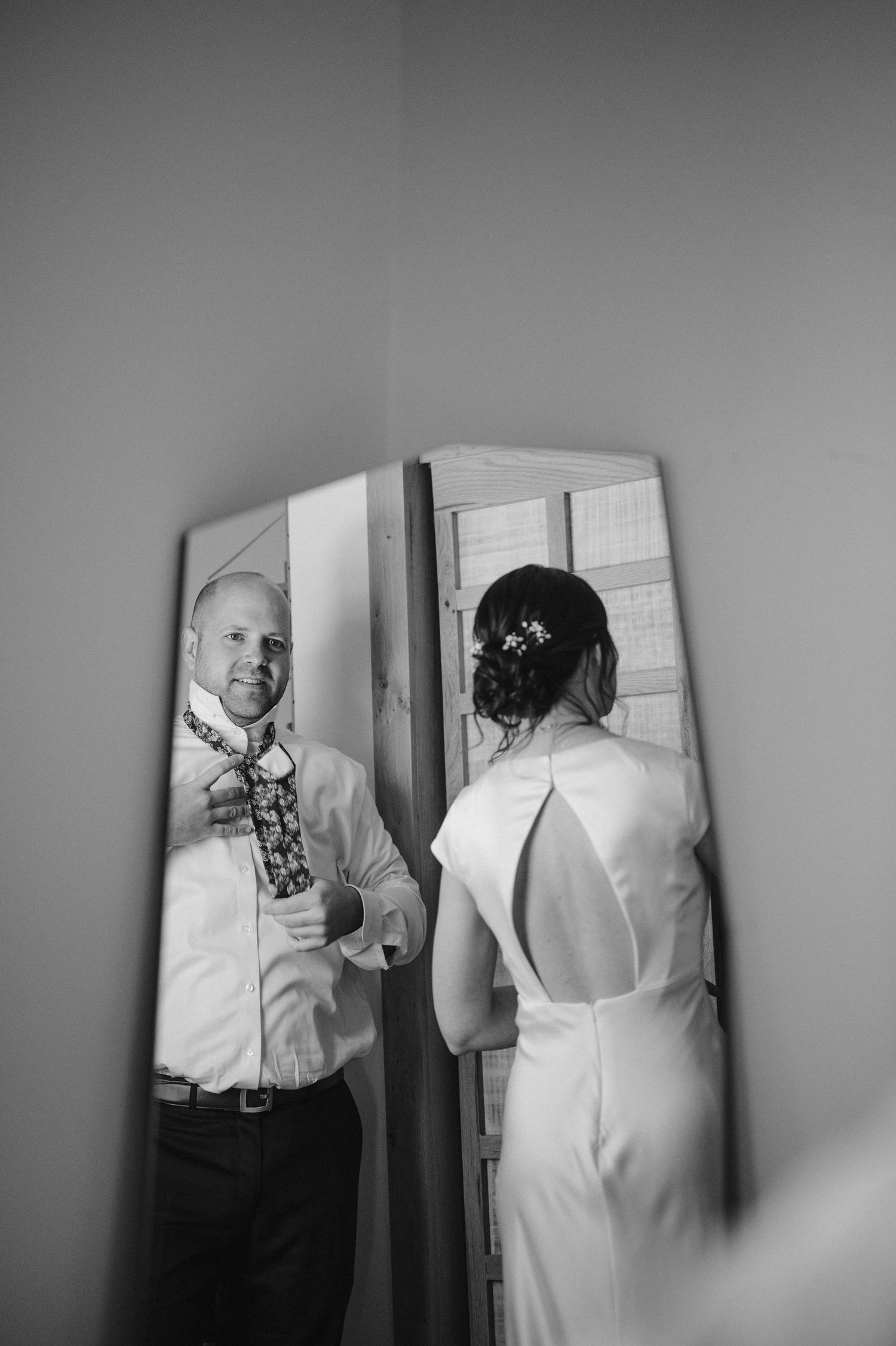 Black and white photos capture intimate moments during wedding preparations.