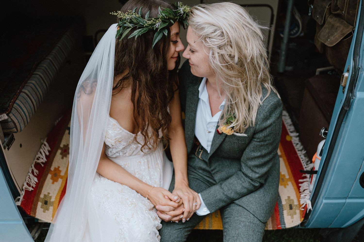 A newlywed couple shares an intimate moment while seated together.