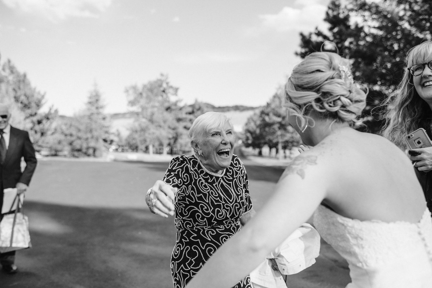Emotional moment shared during outdoor wedding celebration.