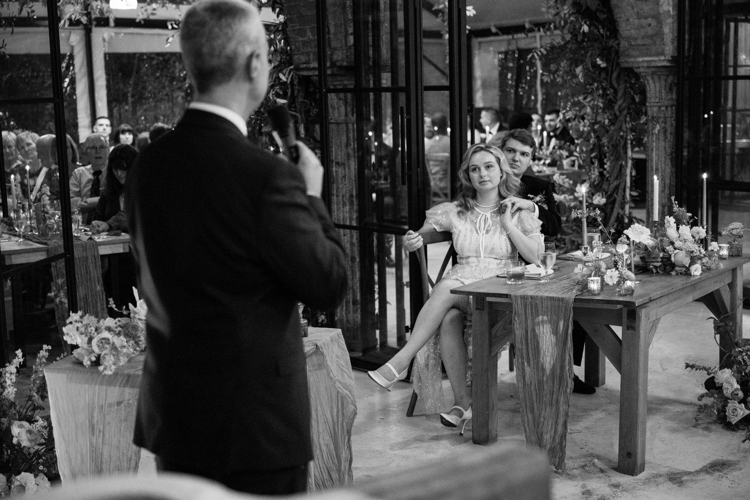 Black and white photo of wedding photography session in a garden-style venue.