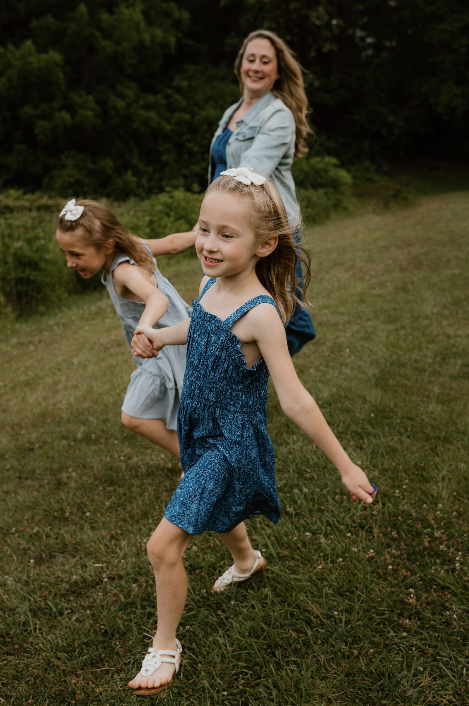 Joyful movement and dancing captured in a candid moment outdoors on a grassy hill.