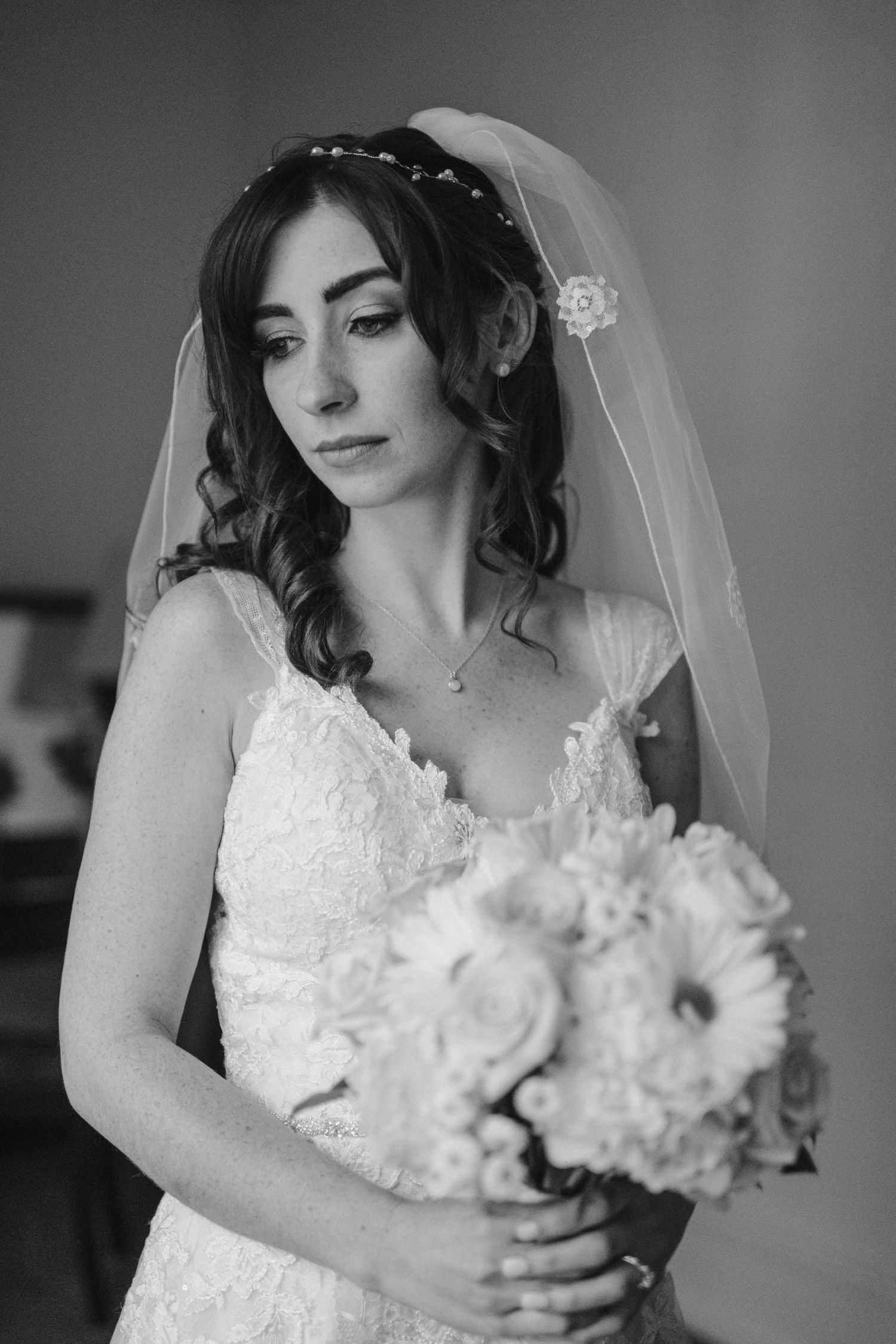 black and white portrait of bride with bouquet in hand