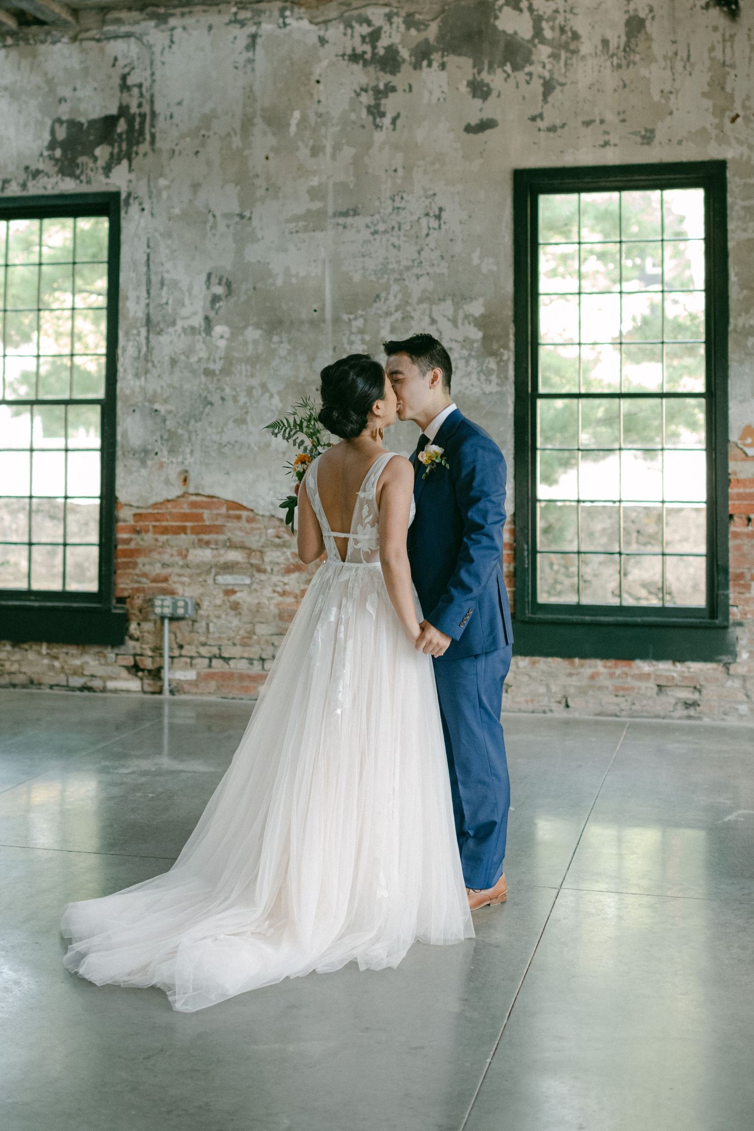 bride and groom kiss in mt washington mill dye house