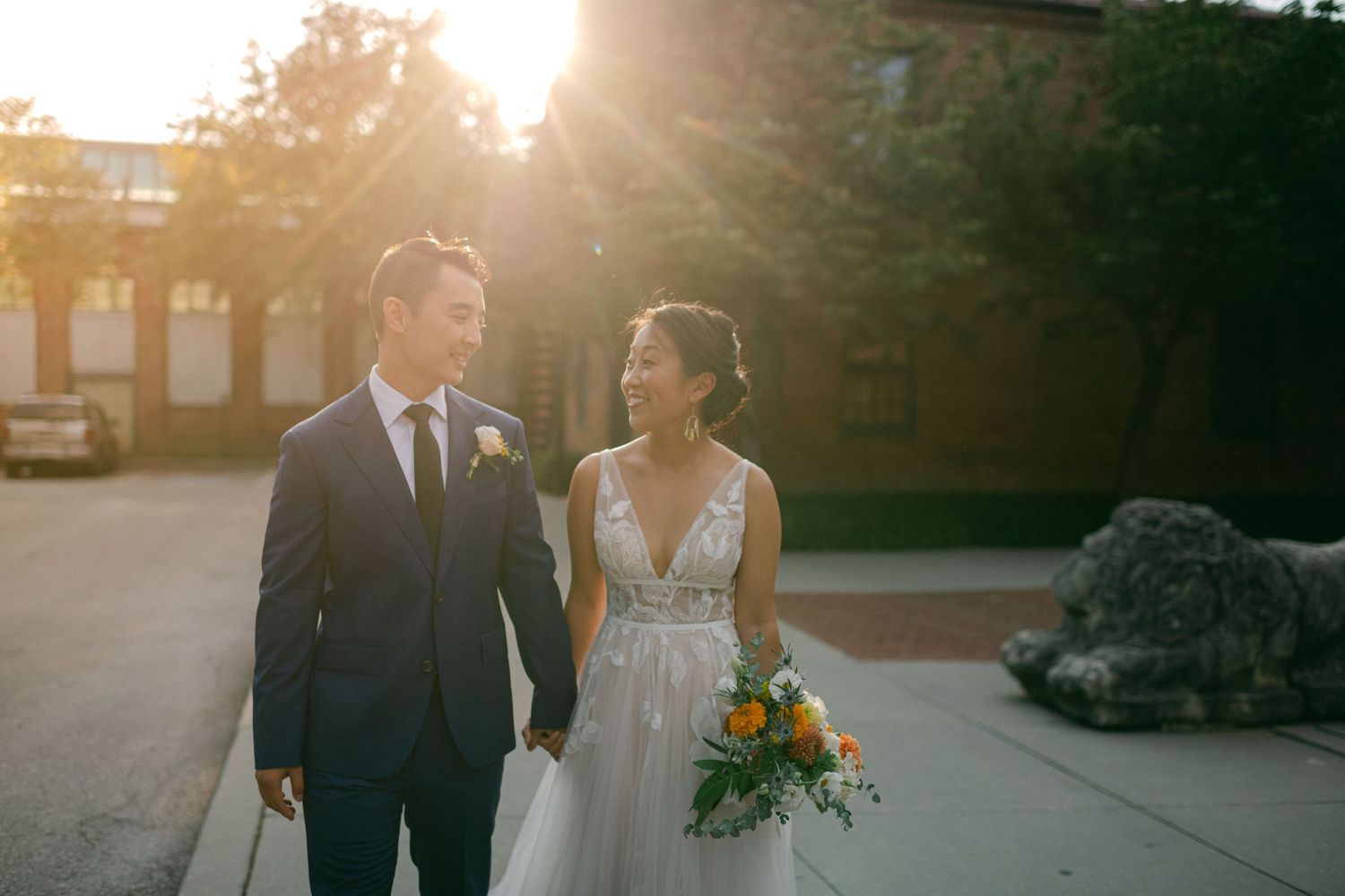 beautiful sun flare lights bride and groom as they smile on their wedding day