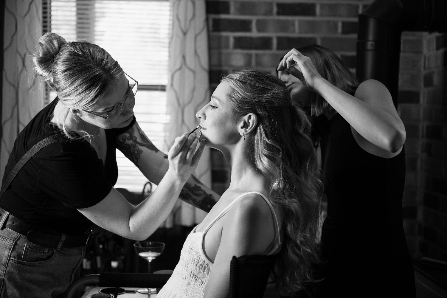 bride gets her hair and makeup done on her wedding day