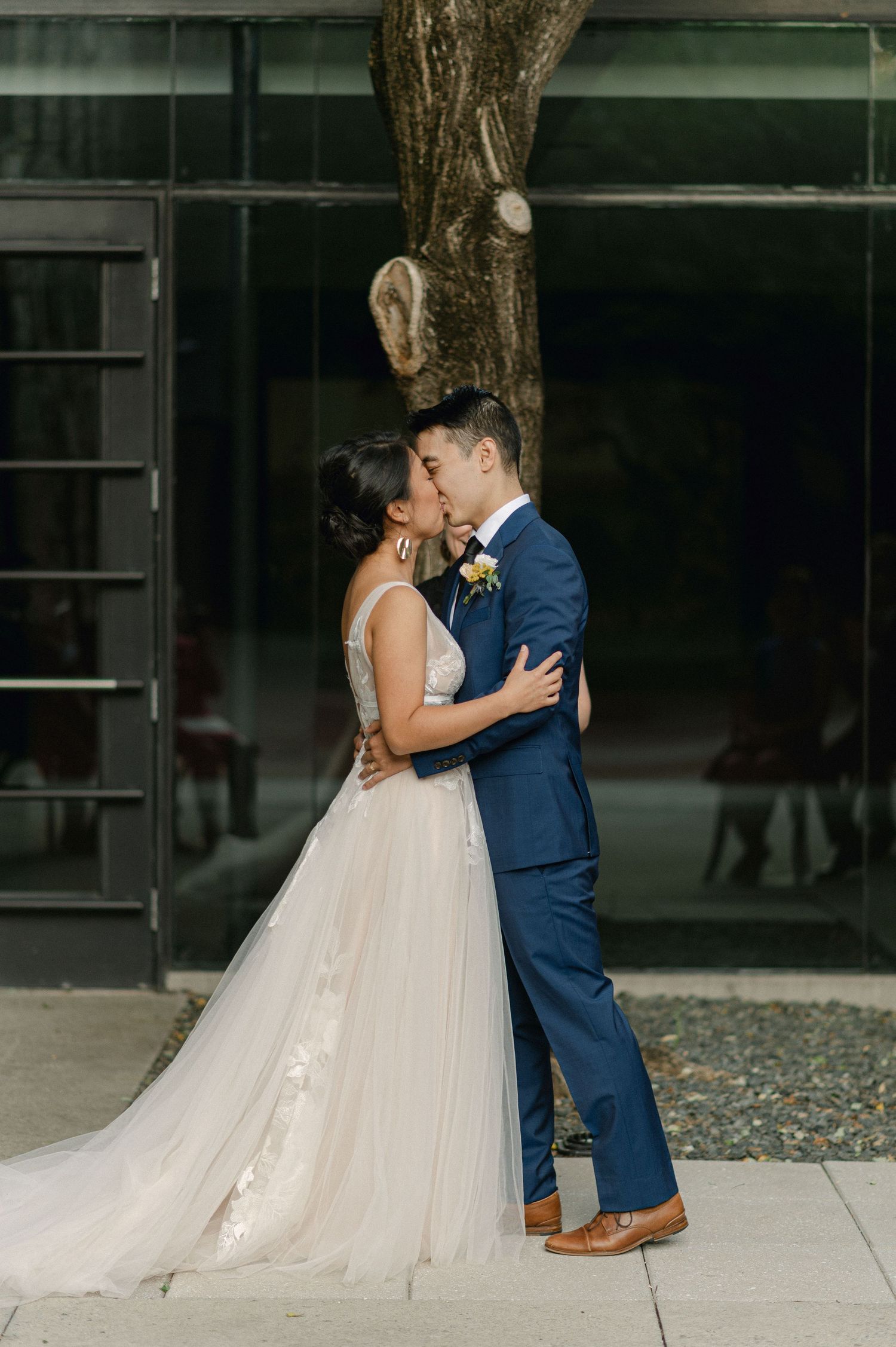 bride and groom kiss at the altar