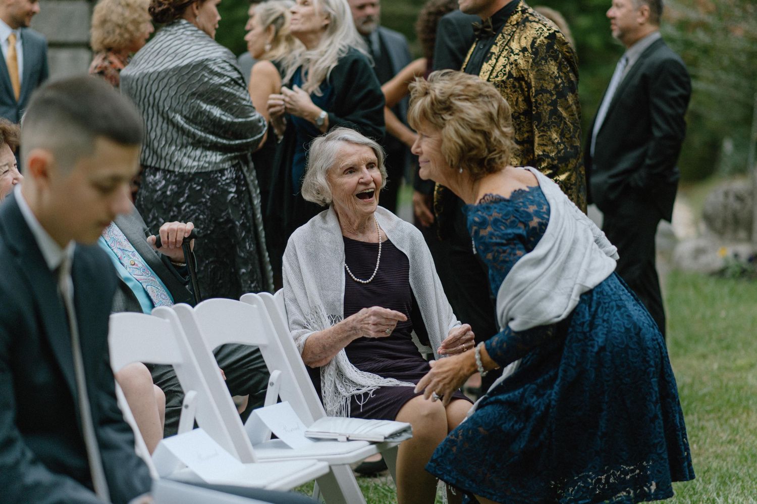 mother of groom laughing with guests at strong mansion wedding ceremony