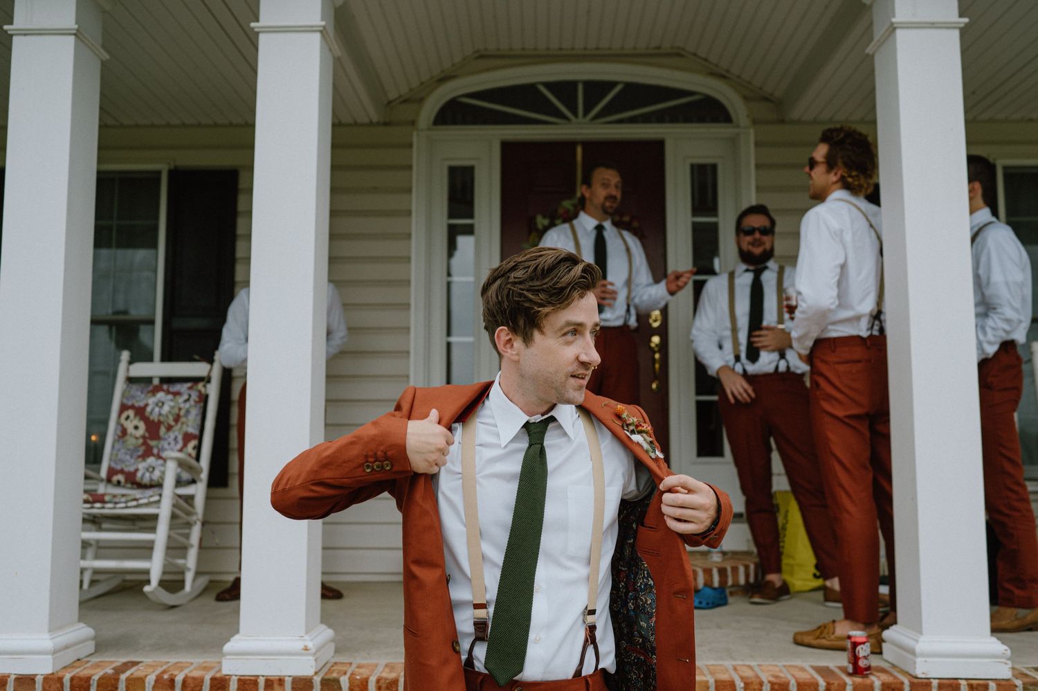 groom getting dresses rust orange suit backyard wedding maryland documentary wedding photographer