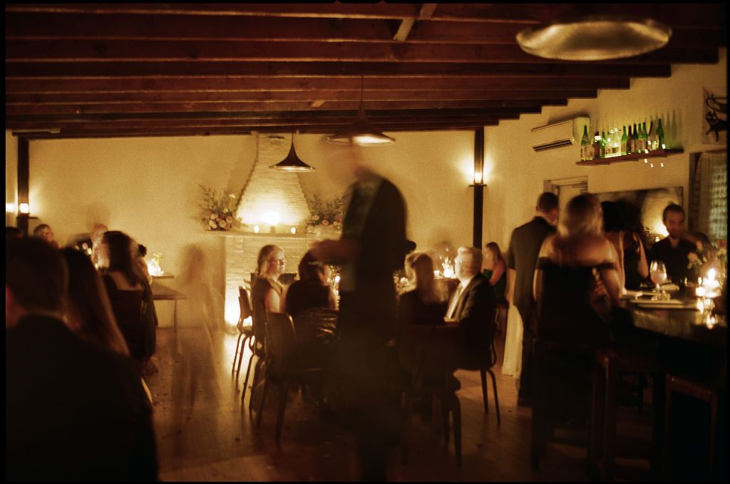 Restaurant interior with wooden ceiling beams and pendant lighting creating warm ambiance Fadensonnon in Baltimore