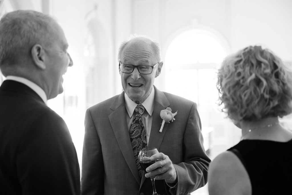 Elegant indoor reception gathering with guests in formal attire.