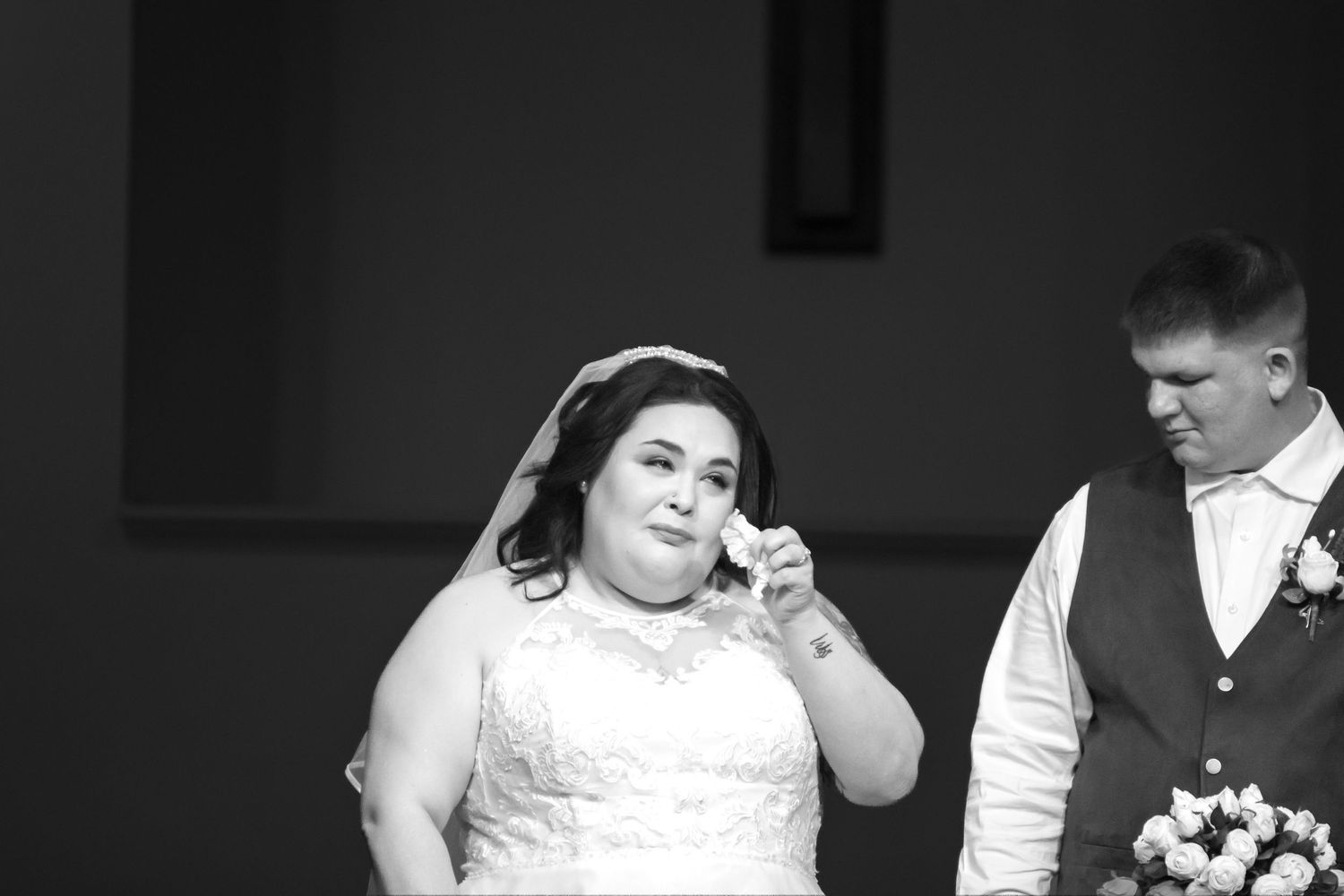 A black and white photo collage showing candid moments from a wedding celebration.