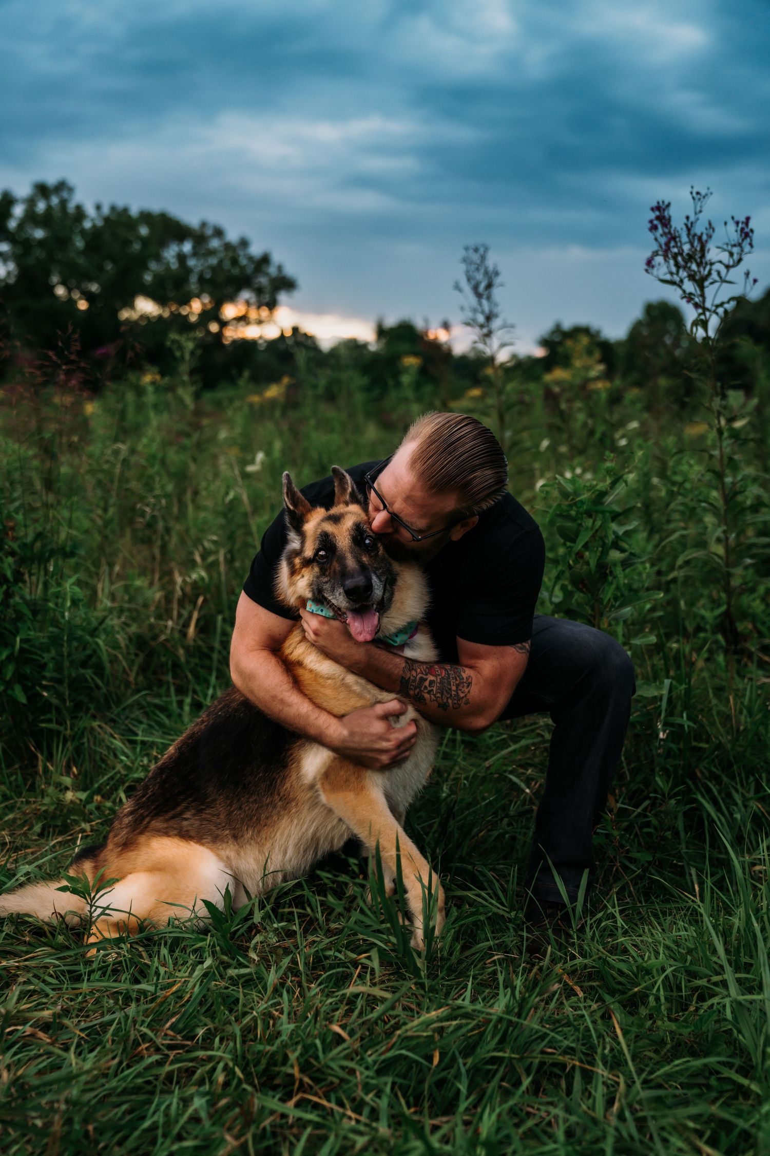 a man hugging and kissing his dog in a field in Cincinnati, Ohio image by a pet photographer. 
photographer near me