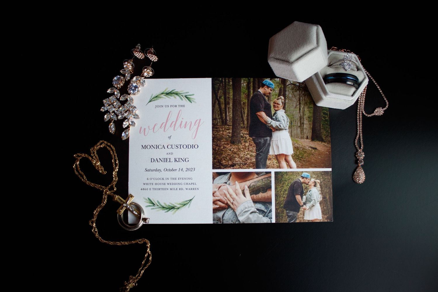 Wedding stationery and invitation suite artistically arranged on dark background with decorative elements.