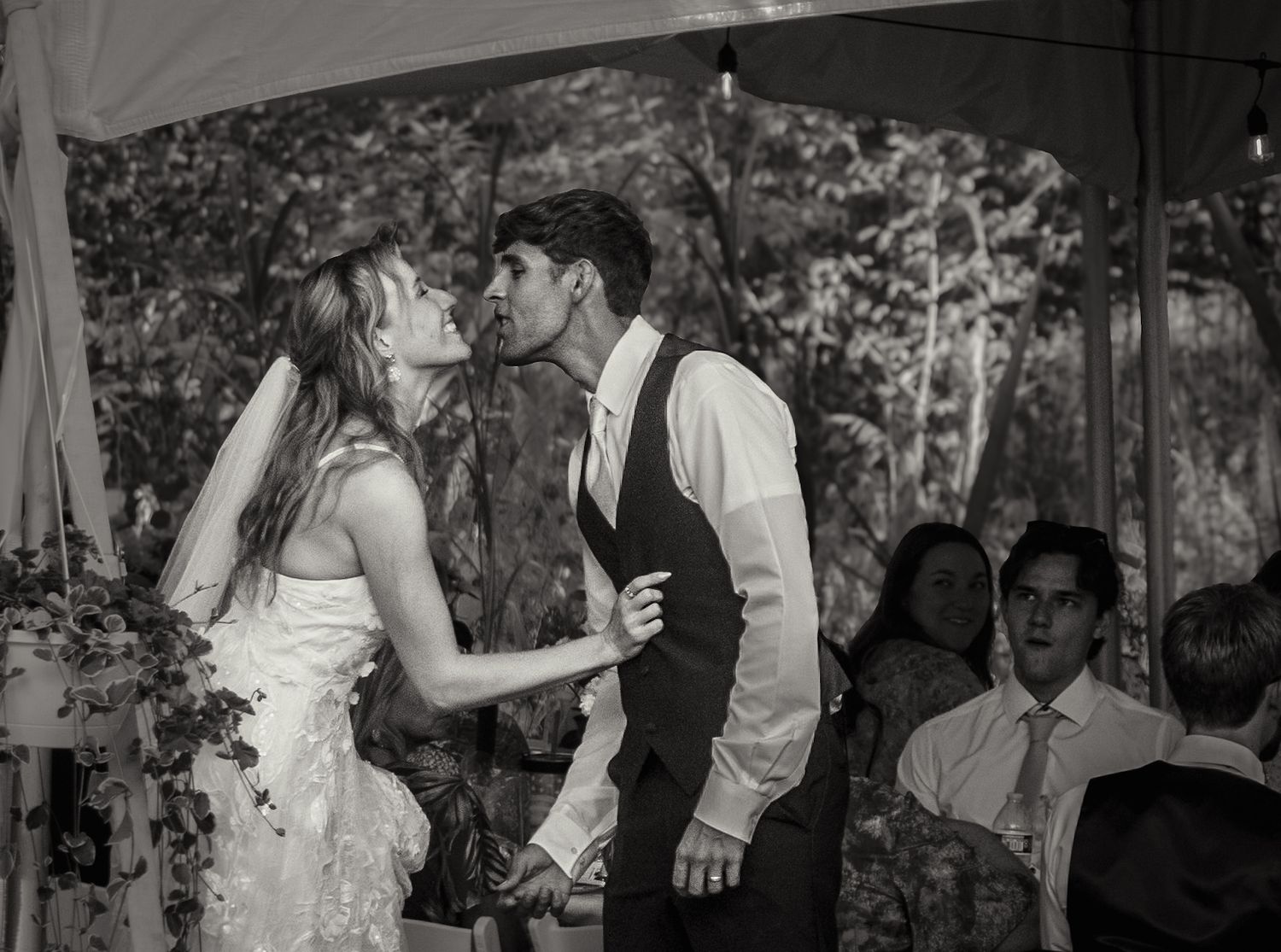 Black and white candid shots of wedding reception dancing and celebrations.