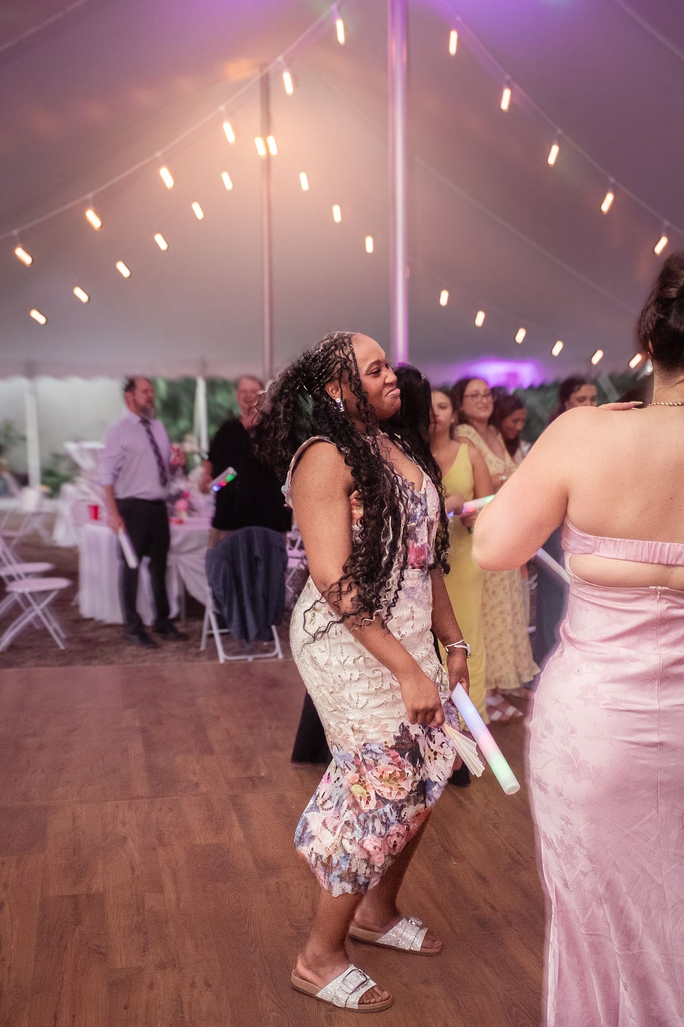 A sequence of wedding reception photos showing dancers on a wooden dance floor under string lights.