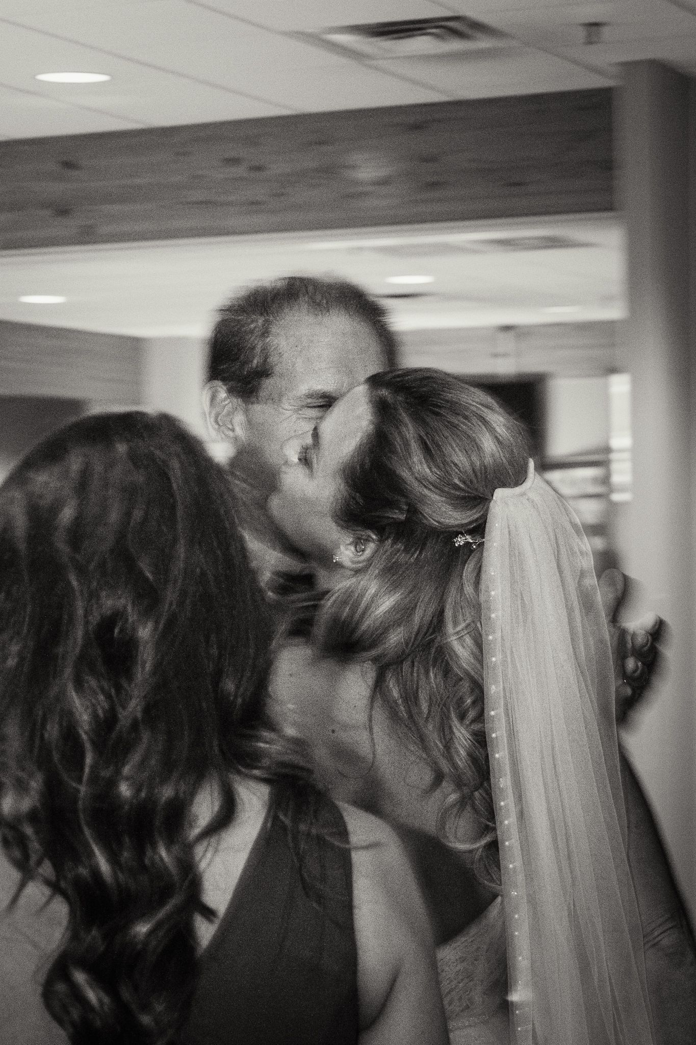 Indoor wedding reception sequence showing intimate moments between guests.