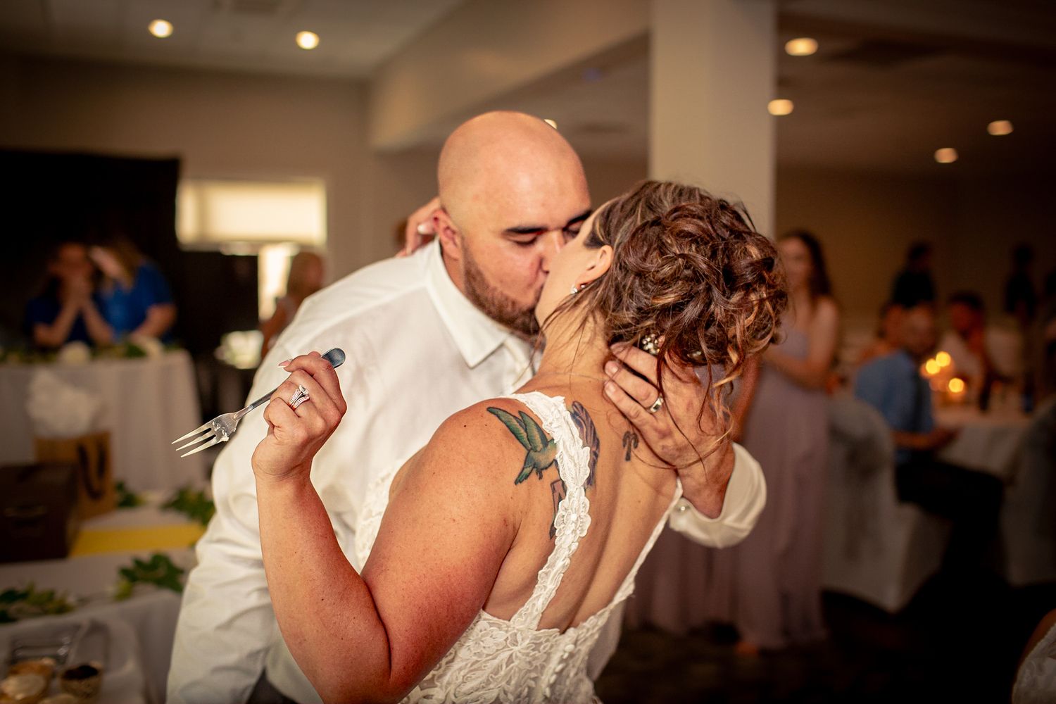 An intimate dance moment during a wedding reception with ambient lighting at Riverwalk Place venue in Gladwin Michigan.
