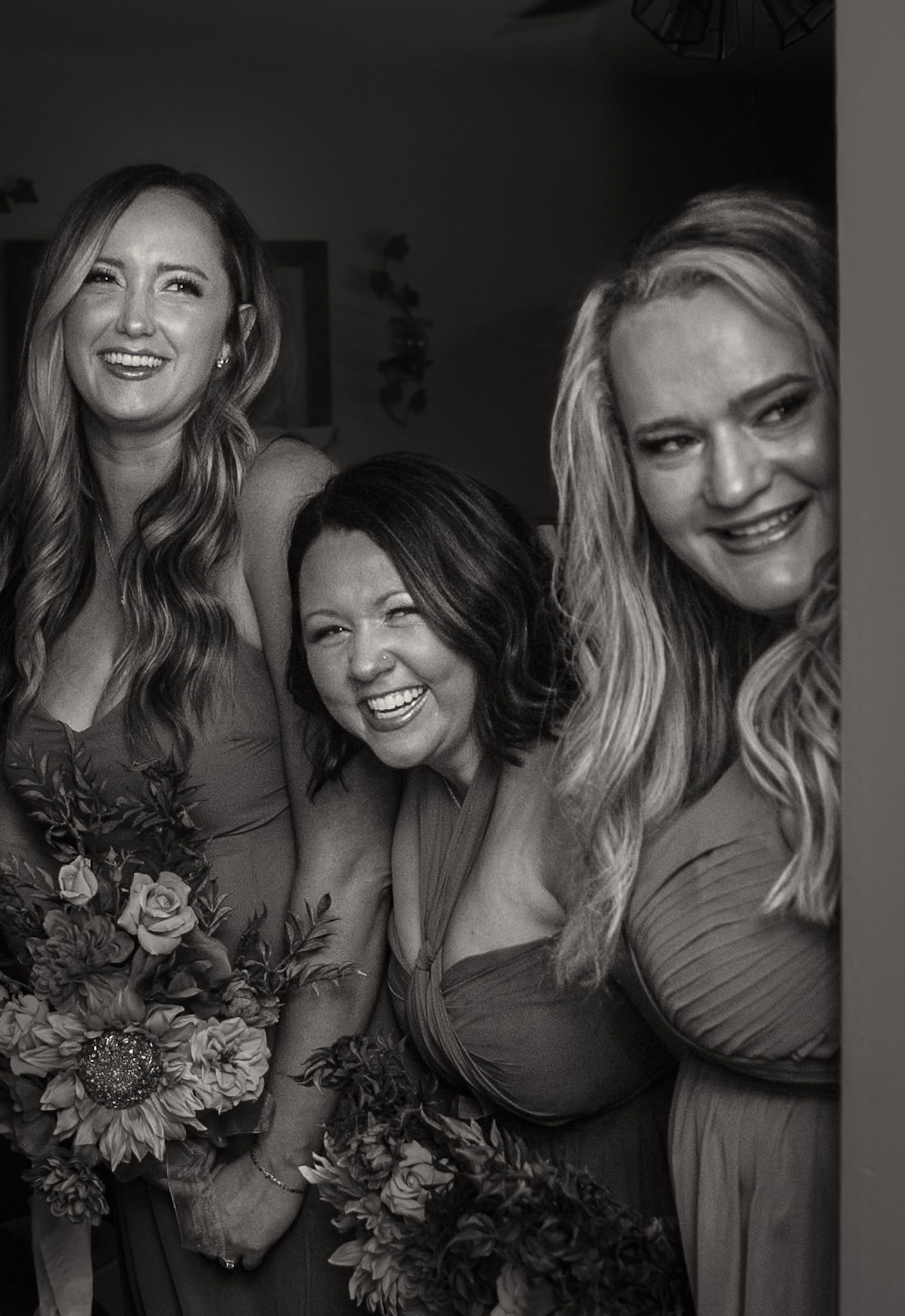 Black and white candid photos show a joyful bridal party laughing and embracing while holding floral bouquets.