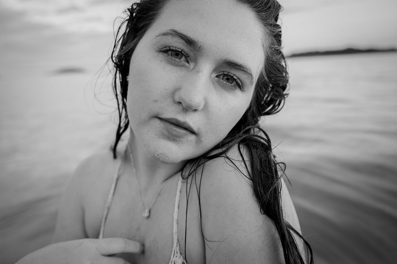 Close-up black and white portrait in water with moody atmosphere.