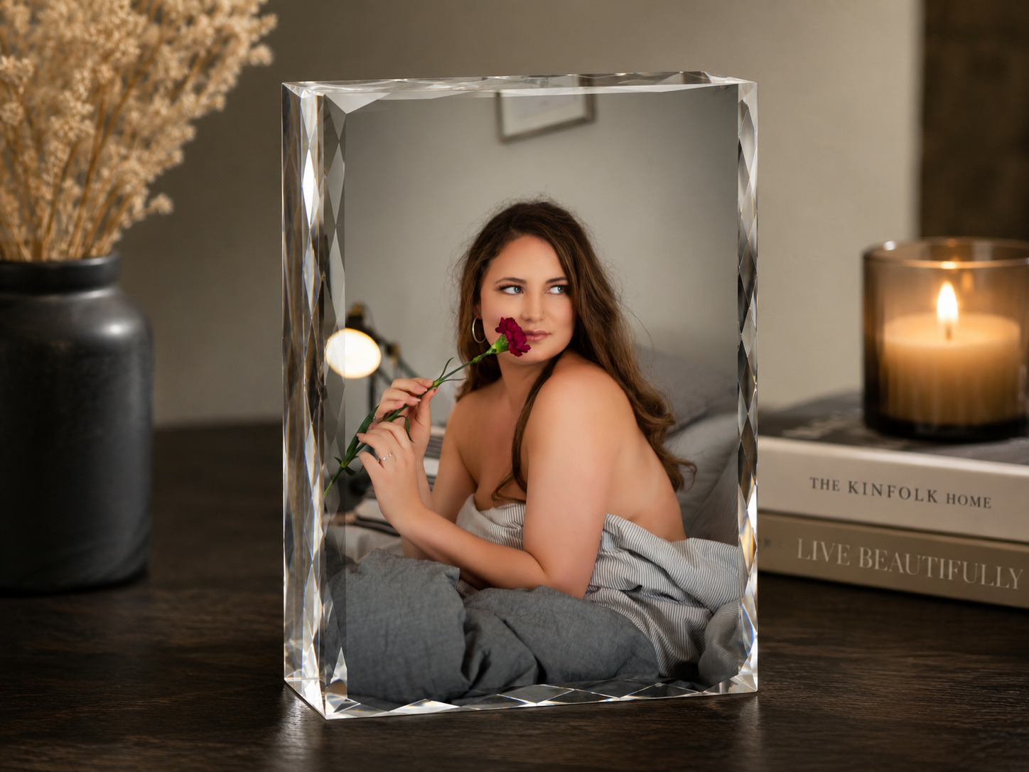 Crystal acrylic photo block featuring a woman posing with a red rose, displayed on a dark wood surface with candle decor.