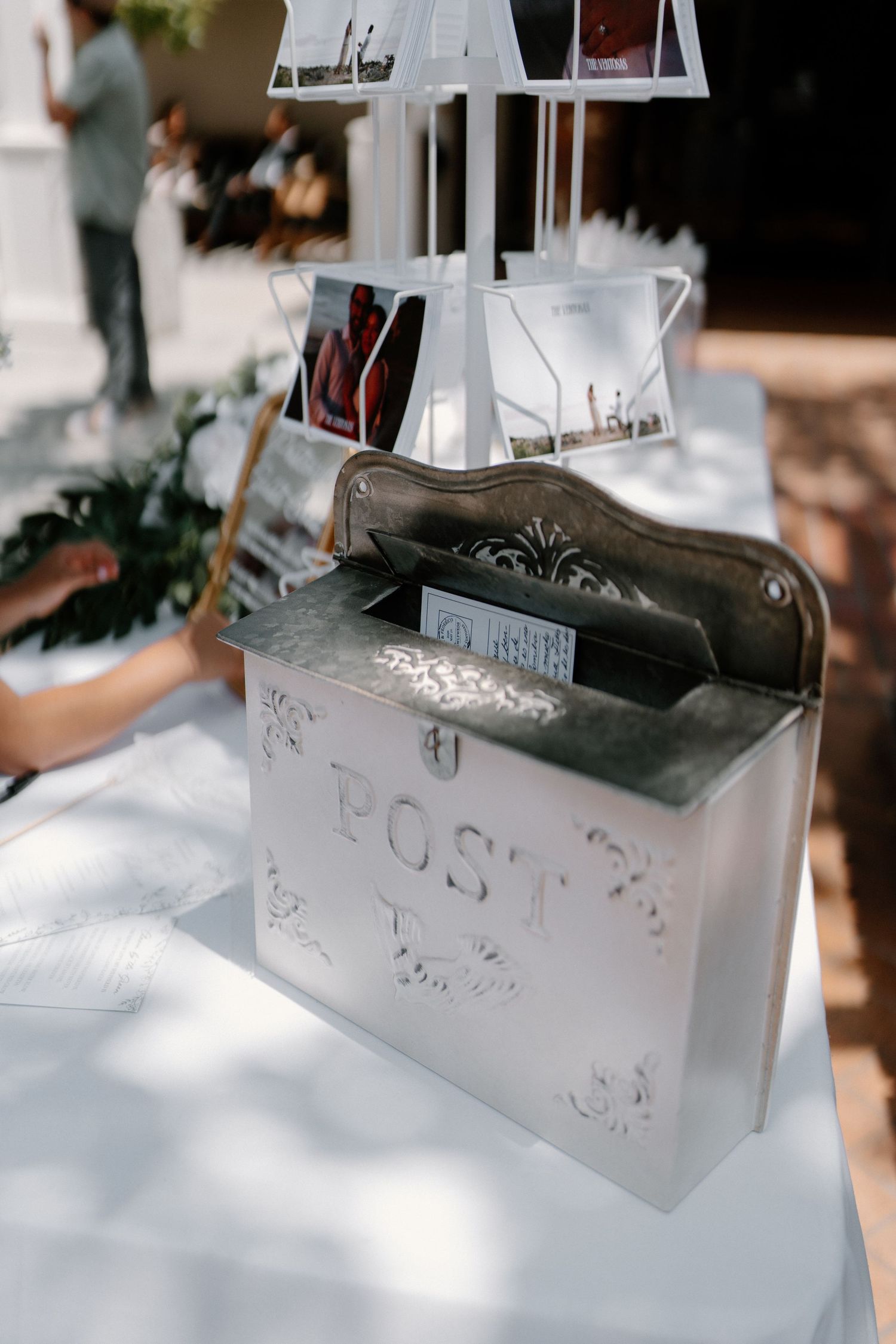 Ornate silver POST mailbox on white table at wedding reception for guest cards and letters.