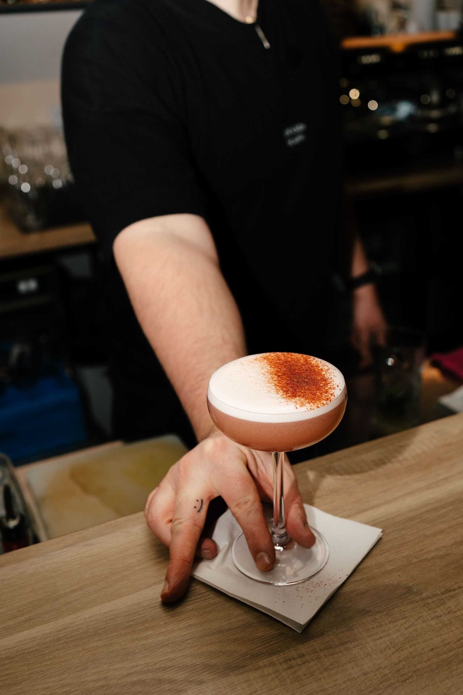 Bartender finishing a cocktail with cocoa dusting at Locanda Scappi, Italian restaurant in Helsinki