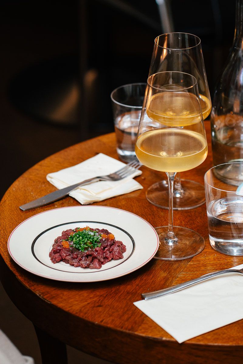 Beef tartare and a glass of white wine at Pinocchio, Helsinki wine bar