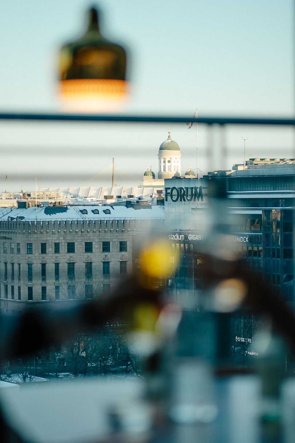 View over Helsinki rooftops from Villa Severino at Kamppi, with the Forum tower in the distance