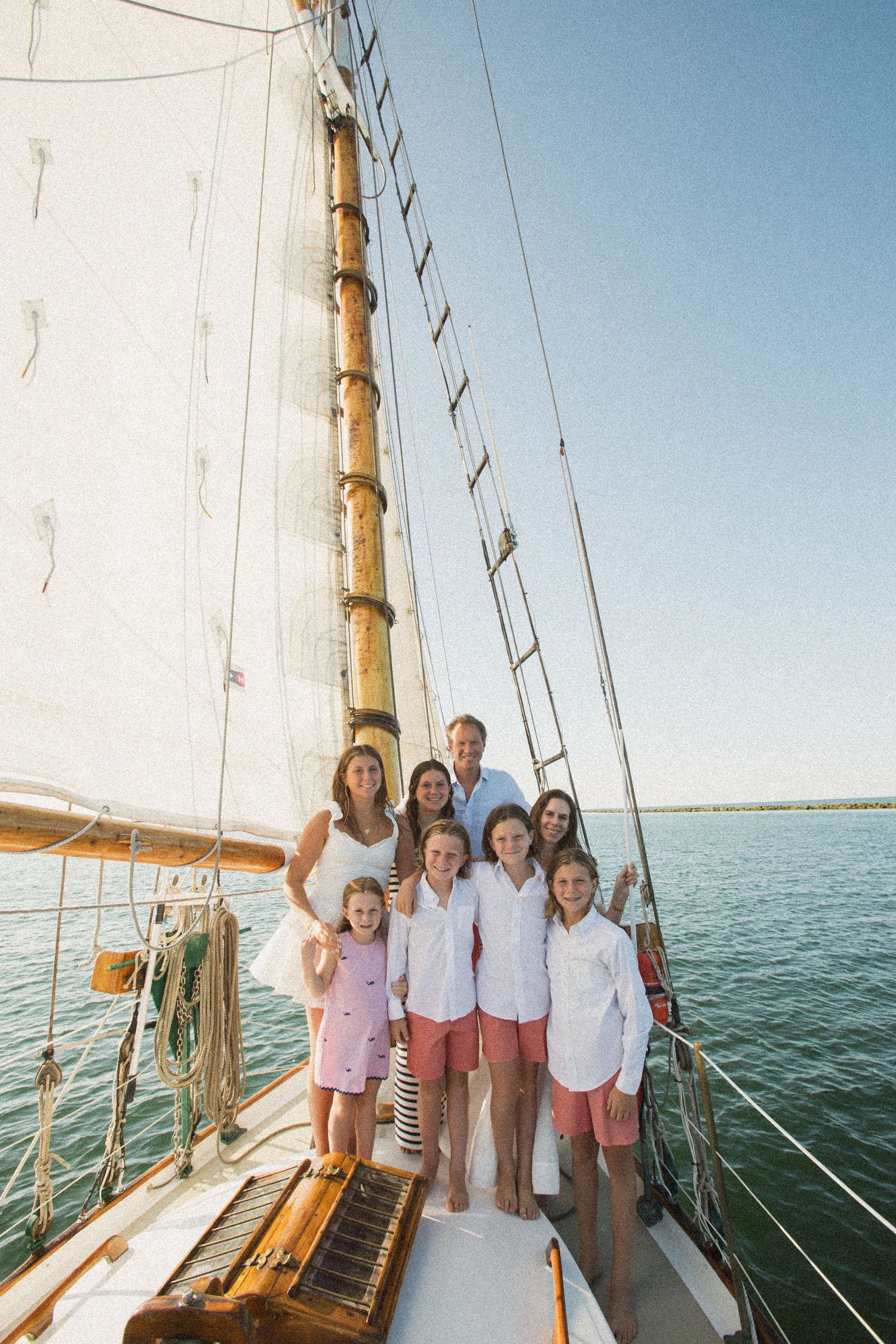 Family group gathered on deck of a sailing vessel during a summer outing.