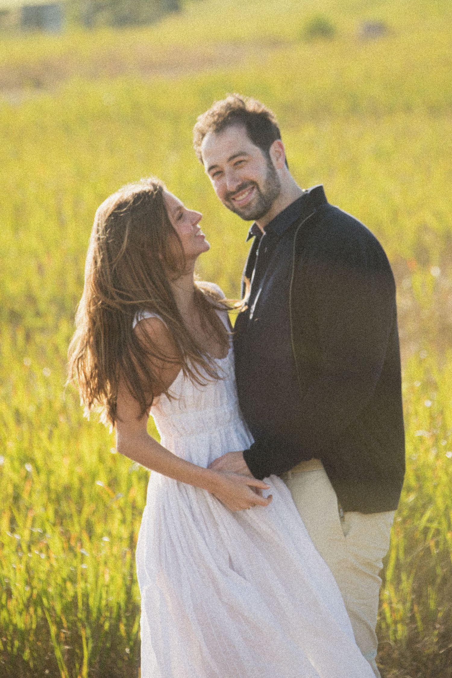 A romantic dance sequence in a golden field during sunset.