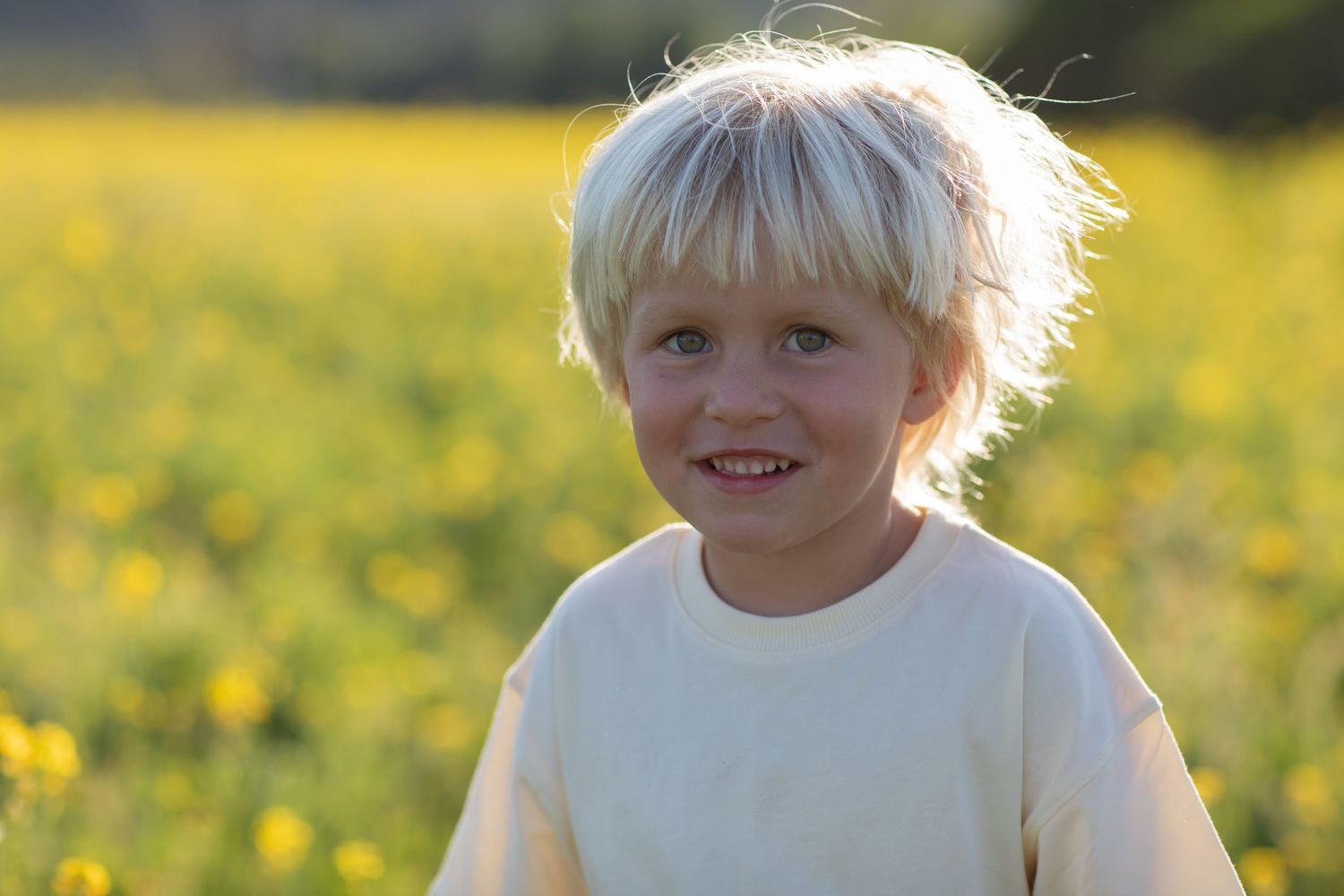 Candid close-up portraits in a sunny yellow flower field.