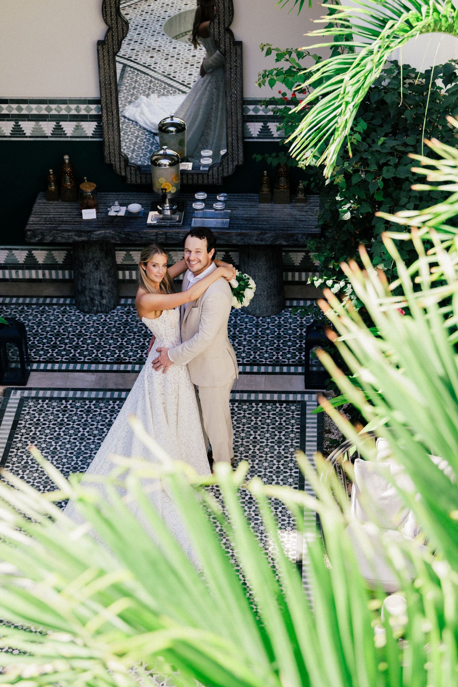 A romantic dance moment captured among tropical plants and ornate Moroccan-style decor.