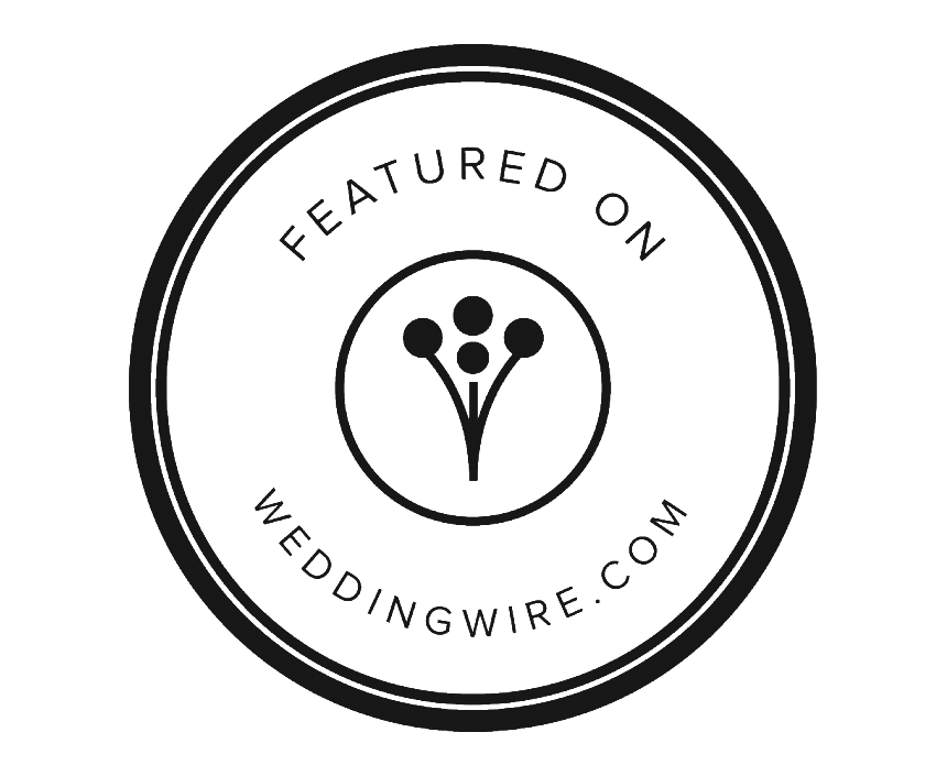 A circular black and white logo badge for WeddingWire.com featuring a floral bouquet icon design.