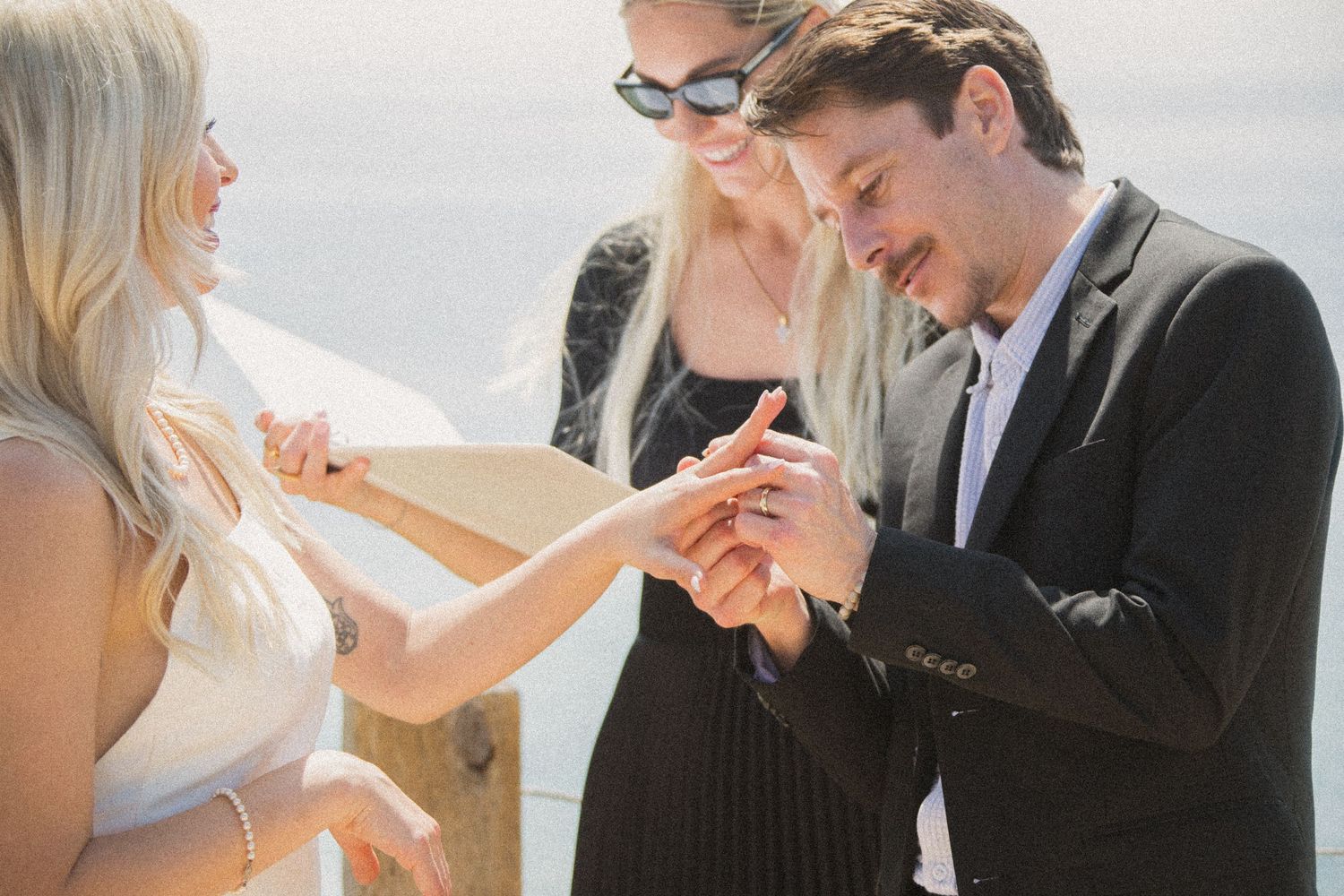 Joyful reactions during an intimate beach wedding ceremony.