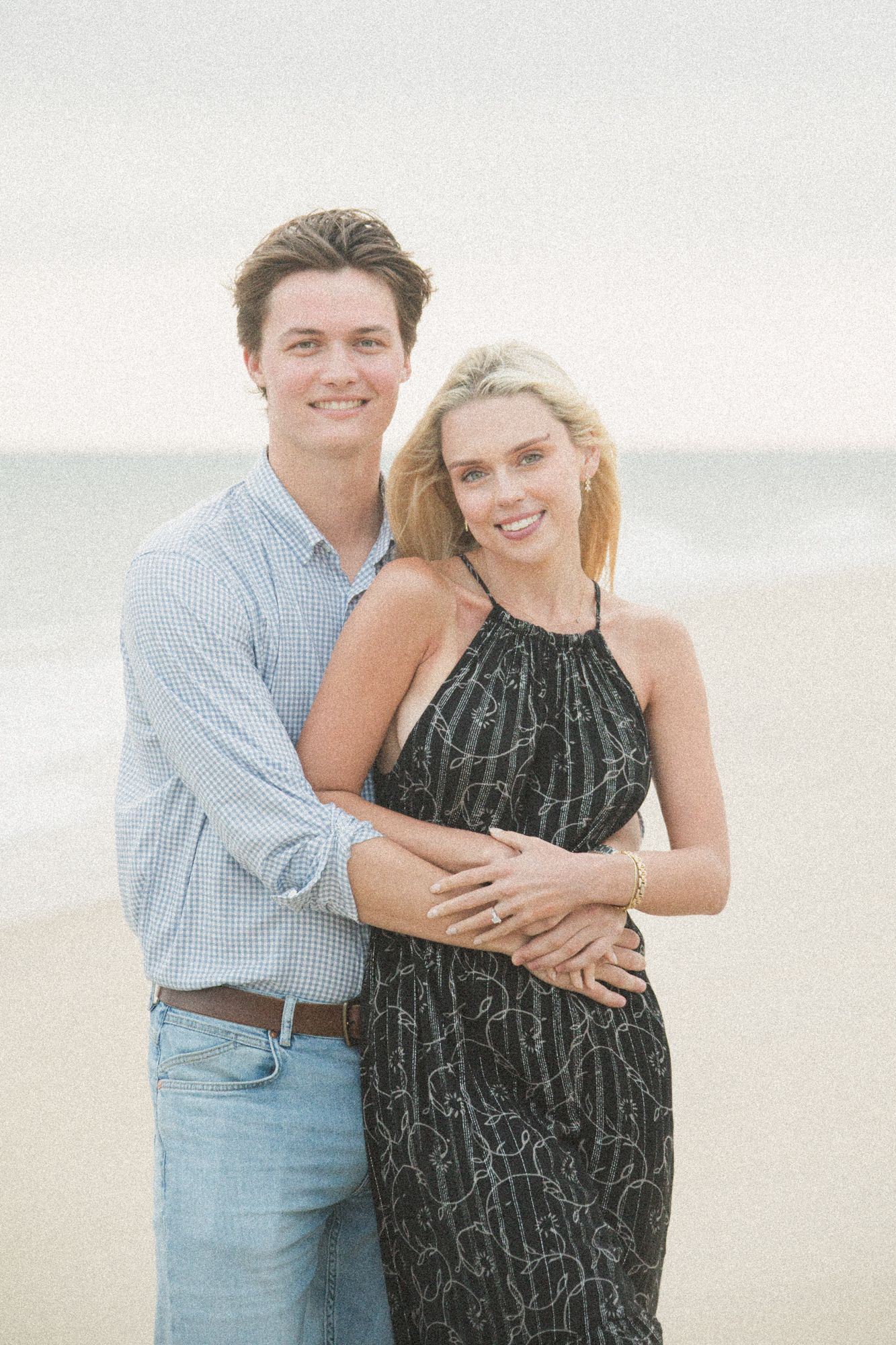 A couple shares a joyful moment together on the beach.