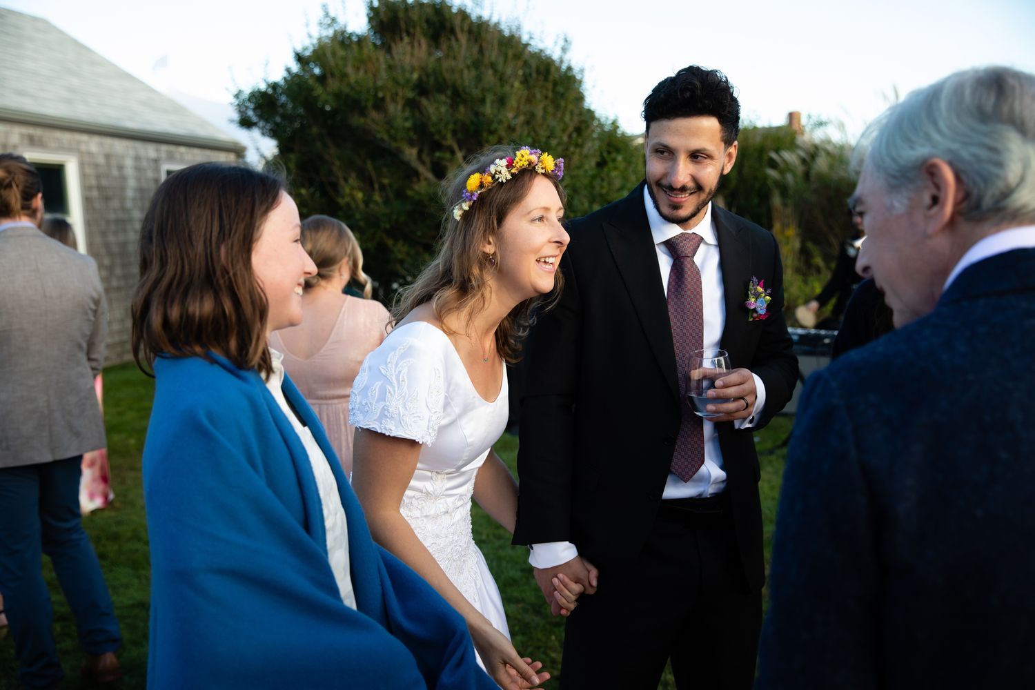 Wedding guests enjoying conversation during an outdoor reception.