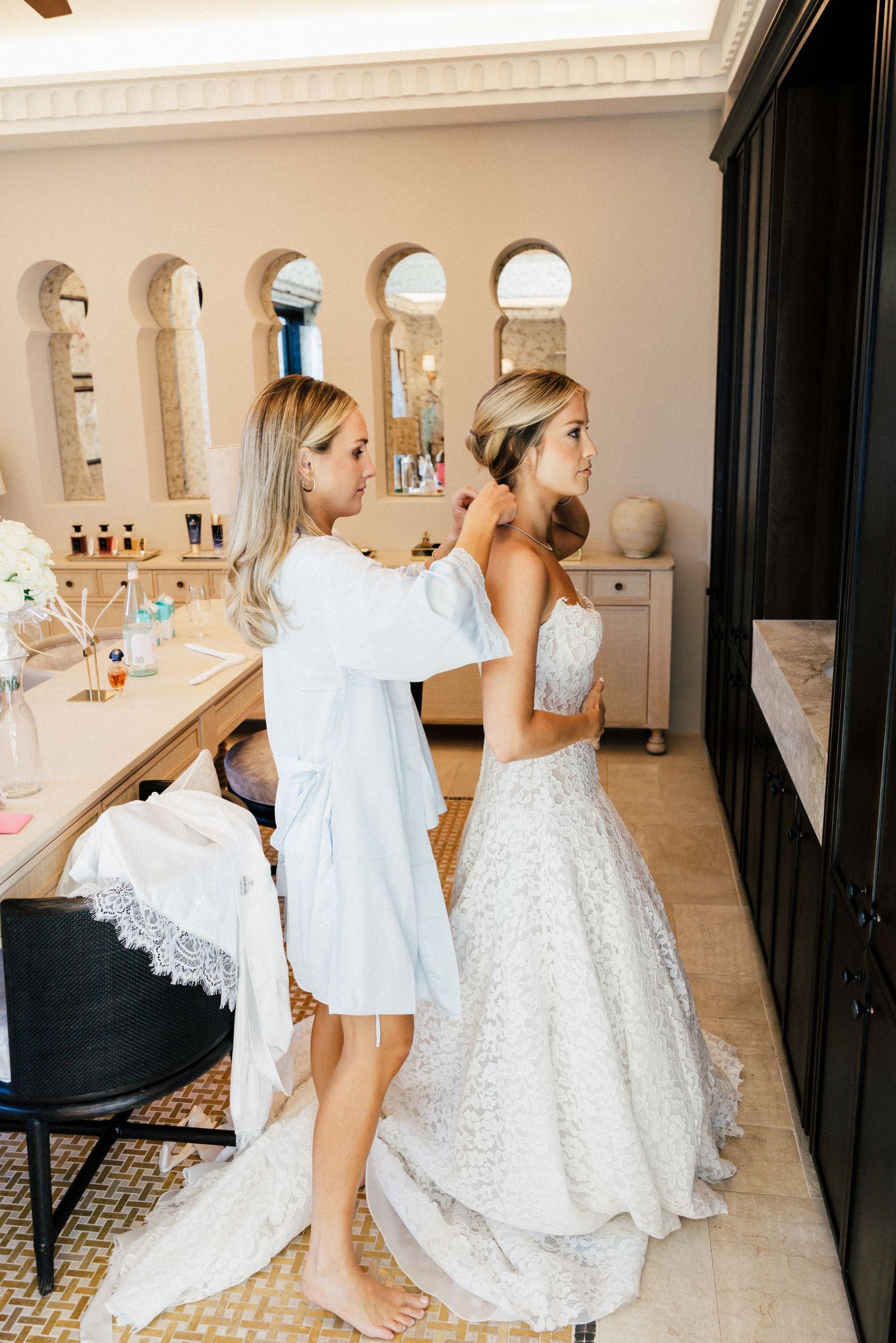 Candid moments of wedding day preparations in a luxurious bridal suite.