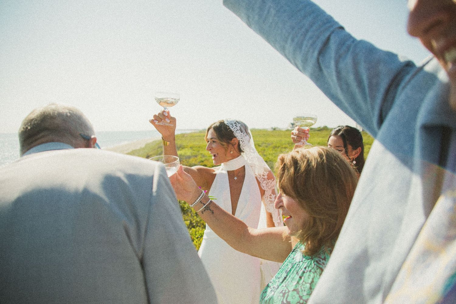 Playful couple enjoying champagne celebration outdoors.