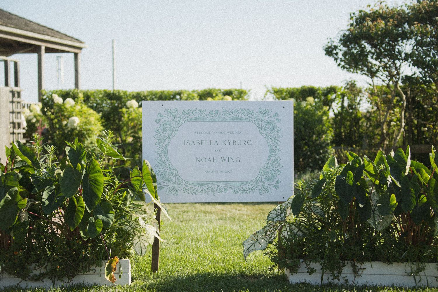 Wedding invitation and stationery details displayed against a natural outdoor background.