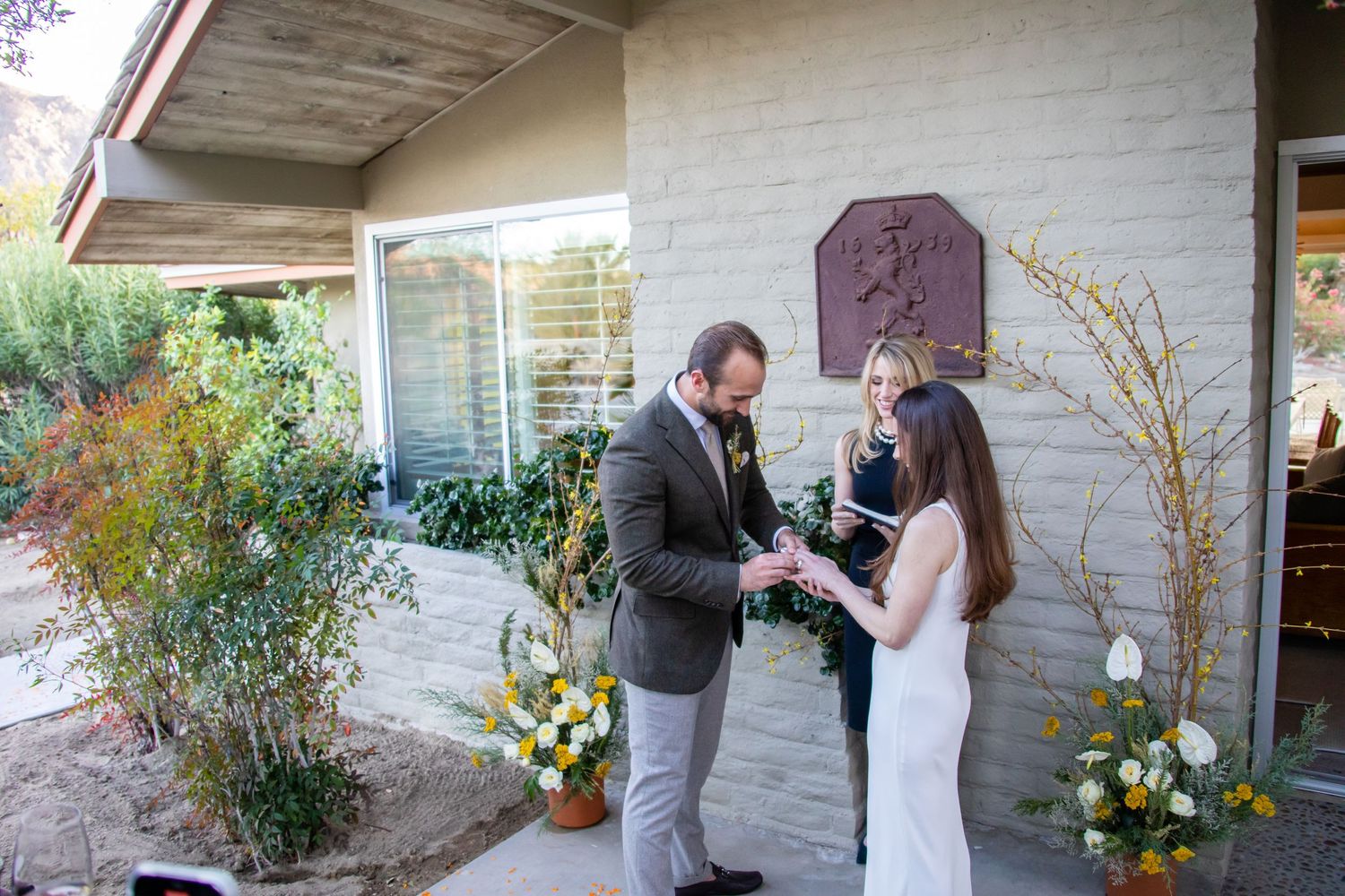 A sequence showing a surprise proposal with yellow floral arrangements against white architecture.