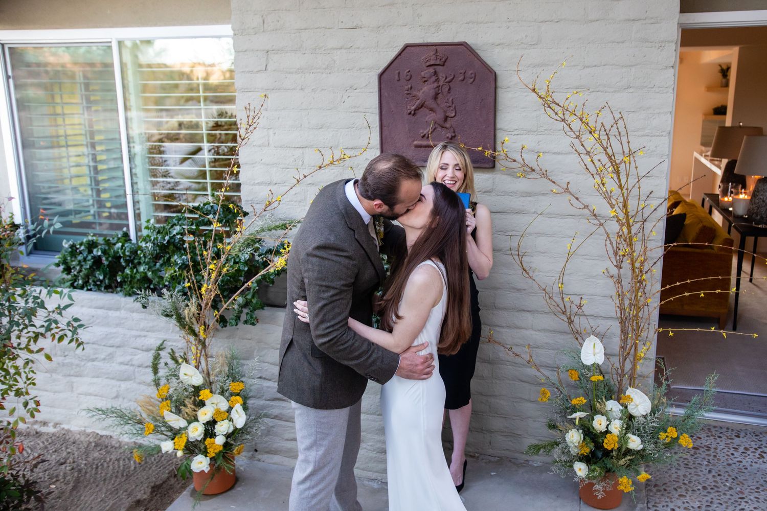 A proposal sequence showing reactions and emotions against a decorated white wall exterior.