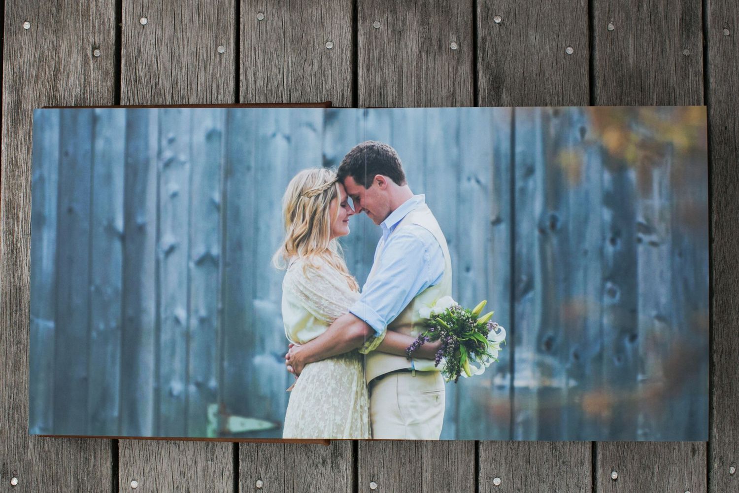 Wedding photograph displayed on rustic wooden background.