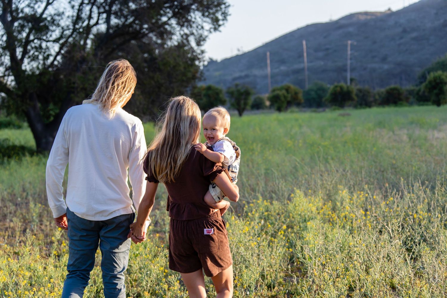 Rolling hills and mountains create scenic backdrop for outdoor photo session.