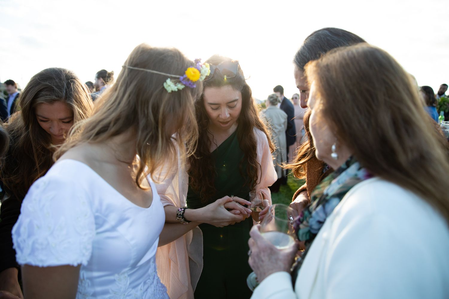 A group of guests gather in a circle during an outdoor celebration.
