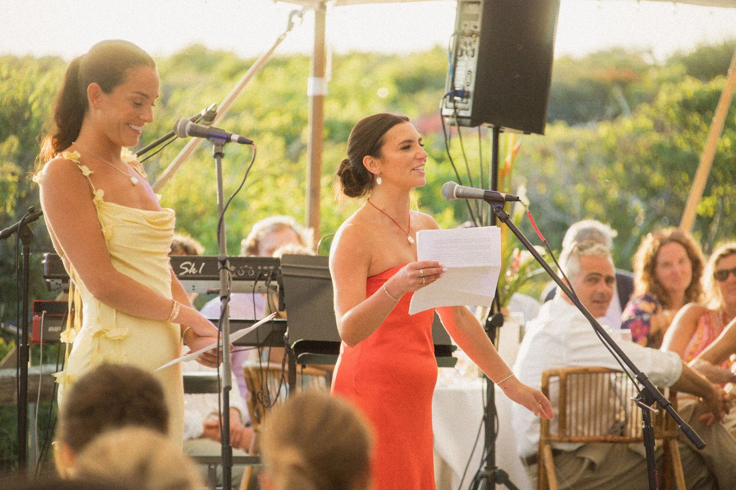 Musicians perform at an outdoor wedding reception during golden hour.