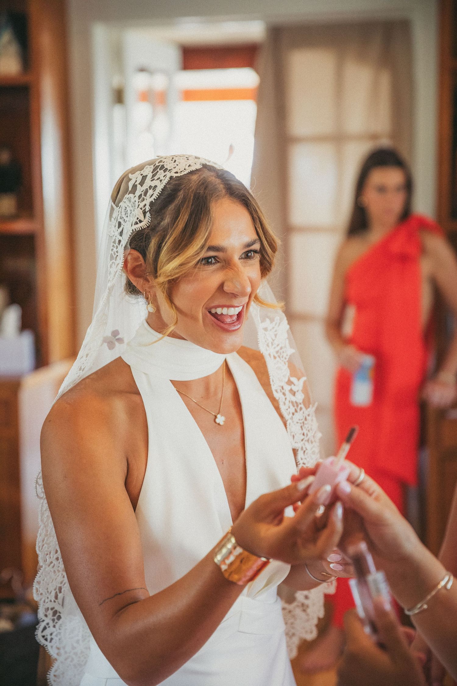 Candid moment during wedding preparations showing joyful laughter.