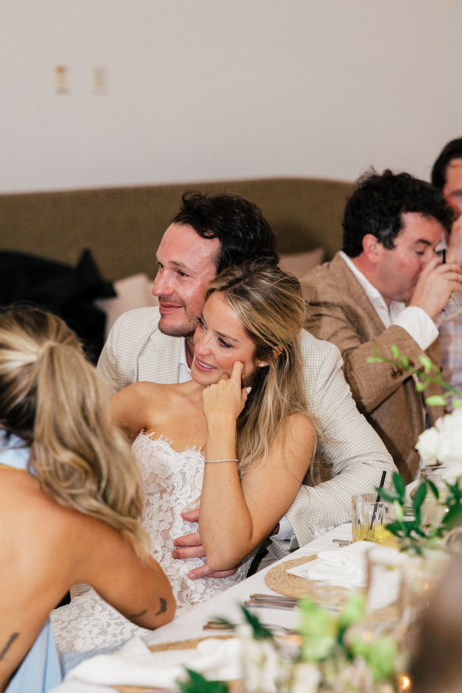 Wedding guests enjoying dinner conversation at an elegantly decorated reception table.