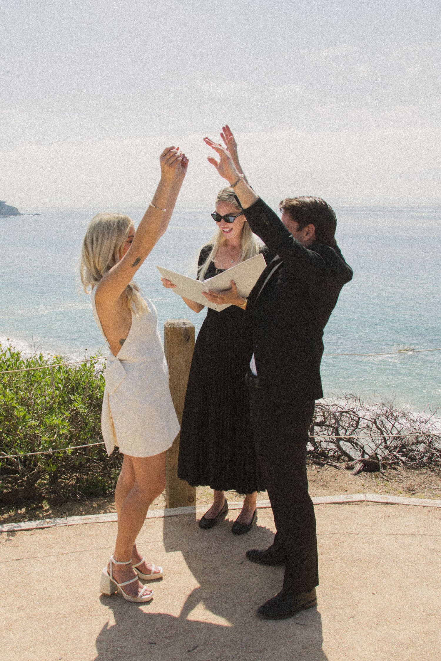 Wedding celebration with dancing and celebration on coastal overlook.